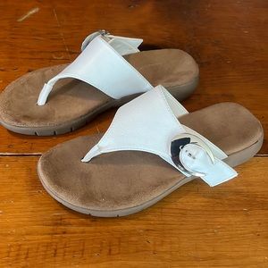 Ladies white slip on sandals.